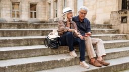 senior couple looking at smartphone