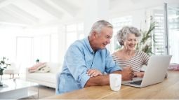 senior couple looking at laptop