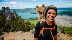 traveler with dog with lake in background