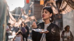 woman eating at food festival