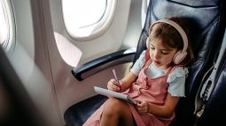 girl on airplane wearing headphones