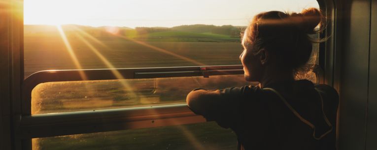 Allianz - woman looking out window on train