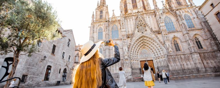 Allianz - Tourist taking photo of the Cathedral of the Holy Cross and Saint Eulalia in Barcelona