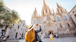 Tourist taking photo of the Cathedral of the Holy Cross and Saint Eulalia in Barcelona