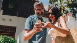 two travelers on vacation looking at phone