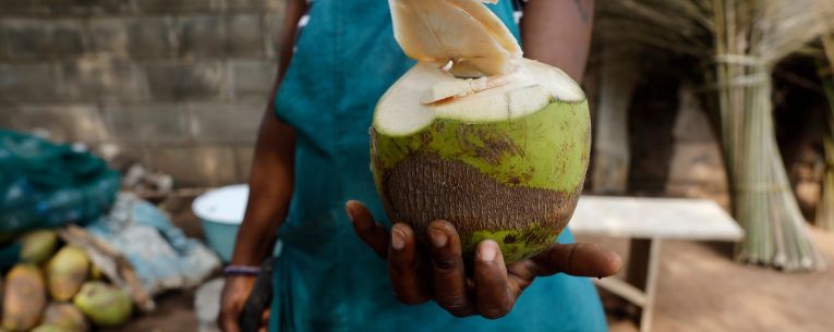 Allianz - woman selling coconuts in lome, togo